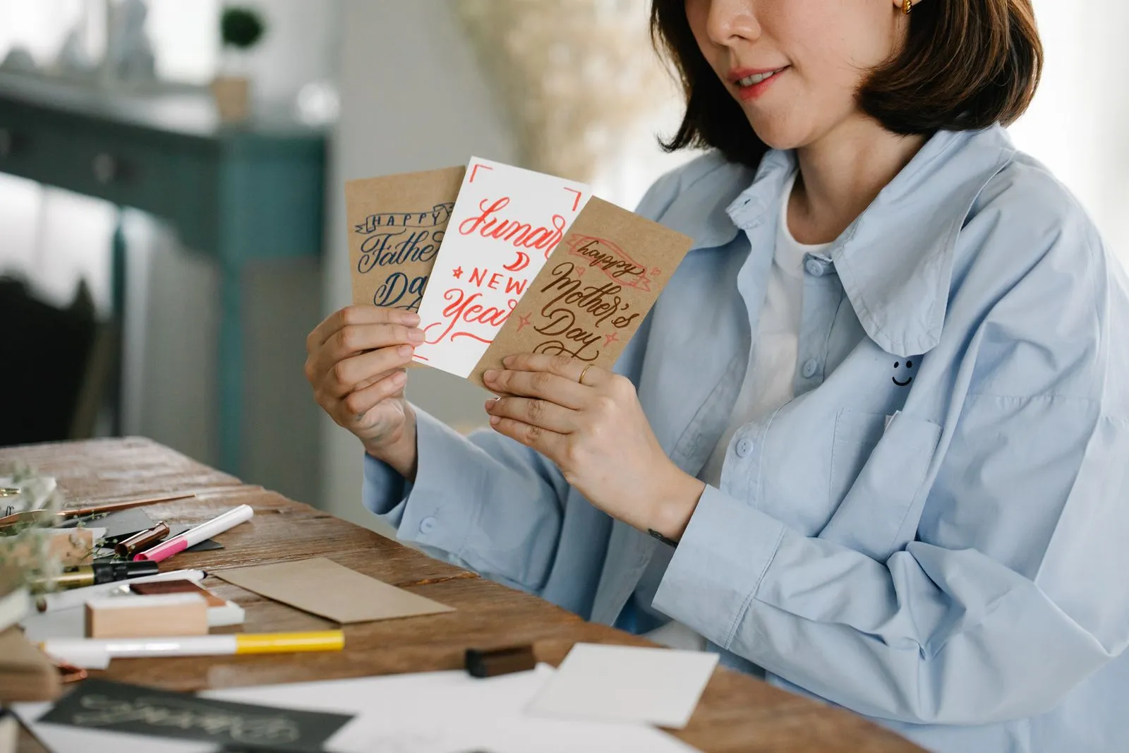 A woman holding a fanned-out assortment of greeting cards